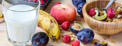 Children's breakfast bowl with muesli, berries, fruits and milk