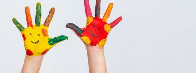 The hands of the child who smeared on the gray background.